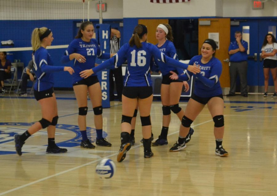 Members+of+the+girls+volleyball+team+congratulate+each+other+after+scoring+a+point.