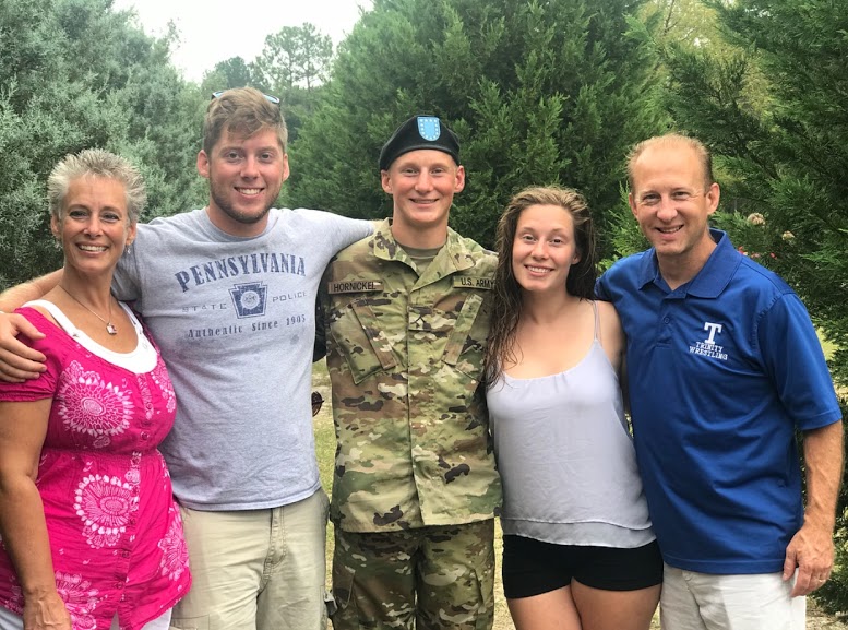 Hornickel (middle) poses with his family after returning home from basic training this past summer.
