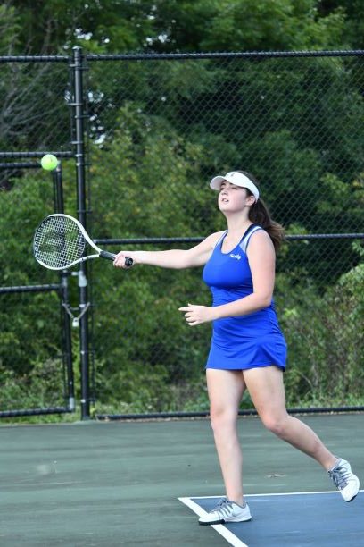 Junior Elizabeth Cowden sets herself up to successfully return the ball to her opponent.