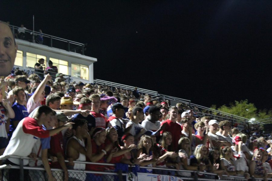 The student section enjoys the crisp fall weather as they cheer on the football team.