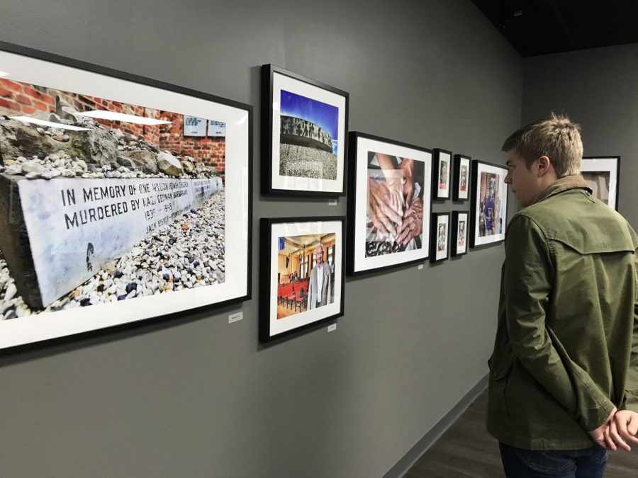 Senior Jonathan Brodak takes time to appreciate some of the photographs in the Roots exhibit at the Holocaust Center in Pittsburgh. 