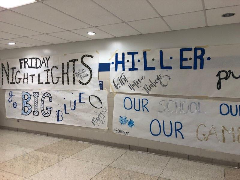 Trinitys cheerleaders promote school spirit by decorating the hallways with positive messages of Hiller Pride.