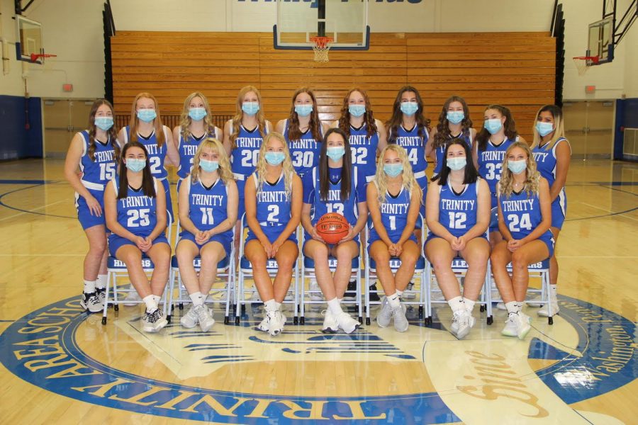 Trinitys girls basketball team for the 2020-2021 season practice mask wearing for their team picture.