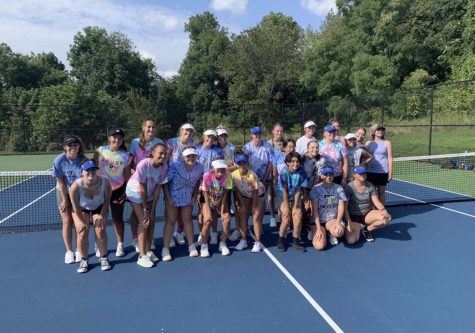 The Girls Tennis team poses in their tie-dye shirts after a hard practice. Tennis may be an individual sport, but the girls on the team still support and have fun with each other. 