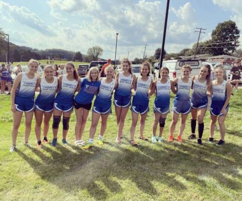 Girls Cross Country stands together for a picture. The girls always come out and cheer for each other during meets, creating a supportive environment. 