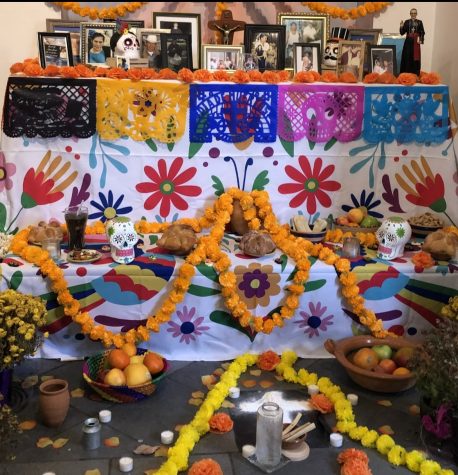 An ofrenda is decorated with bright orange flowers, loved-ones favorite foods, and other symbols. Every year, this is how part of the local Hispanic community celebrates El Dia de Los Muertos.