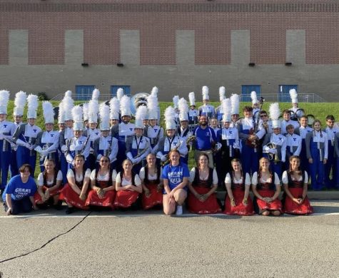 The Trinity Marching Band poses for a picture at Norwin High School before their first competition of the season. Color guard members can be seen in costumes to embody the Grimms fairy tales theme.    