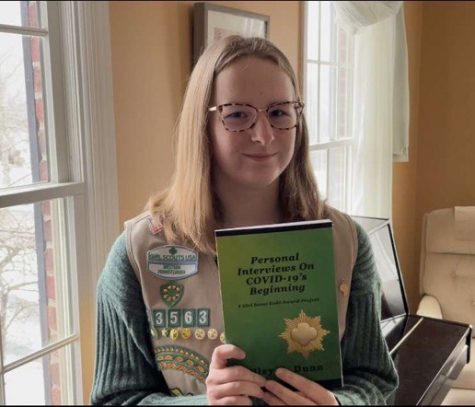 Junior Riley Dunn poses holding her book that she wrote for her Gold Award Project. She hopes the book will help people see they are not alone.