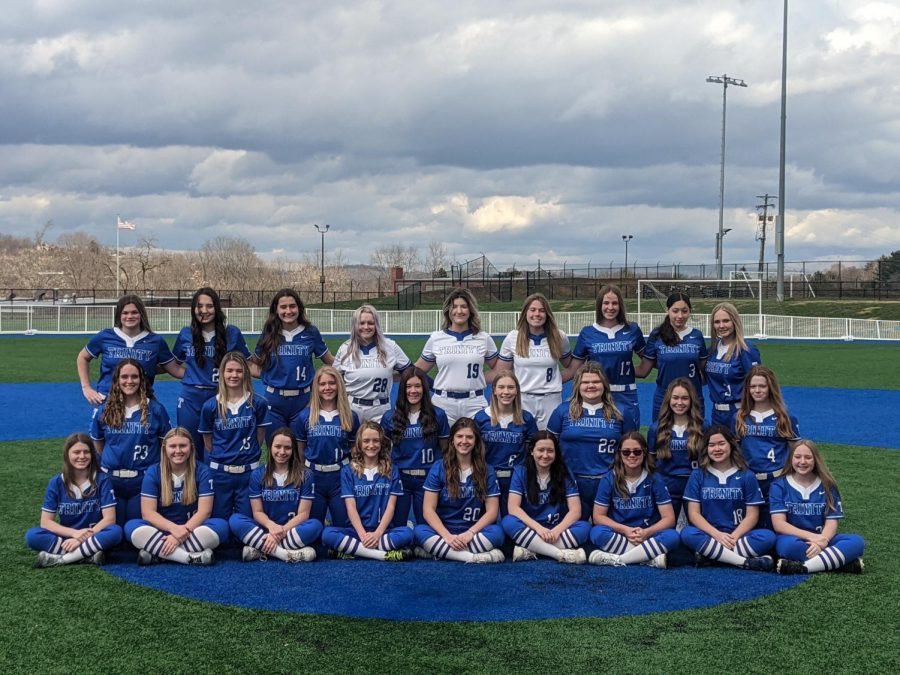 Pictured+above+is+the+entire+Varsity+softball+team+at+their+team+picture+day%3B+underclassmen+are+in+blue+and+seniors+are+in+white.+%0A