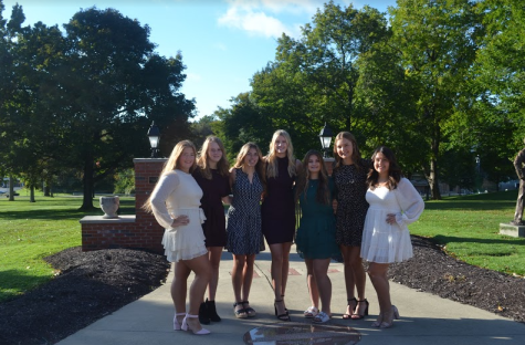 Senior girls on Homecoming Court prepare for the crowning of Homecoming queen the evening before the homecoming dance at the Friday night football game.