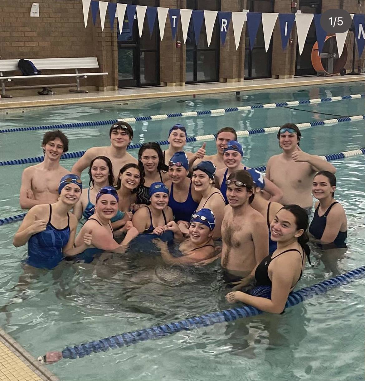 Pictured is the varsity swim team gathering in the pool after their home scrimmage against Uniontown on November 30. They are excited to continue through this season and are striving for many wins.