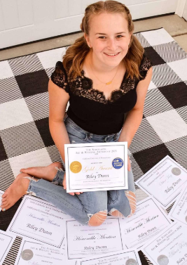 Senior and Hiller newspaper editor, Riley Dunn poses with her many Scholastic awards. Dunn has participated in the Scholastic competition for the past six years. Congratulations Riley!

