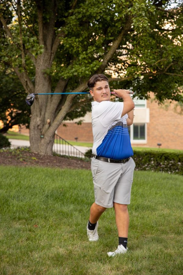 Morris swings and strikes the golf ball during a Trinity match. 