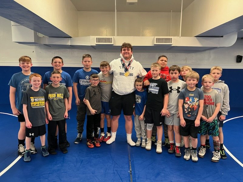 After+being+awarded+WPIAL+Champion+and+State+Qualifier%2C+Banco+talks+with+youth+wrestlers+giving+them+advice+before+heading+to+States.+%0A