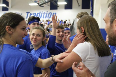 Seniors congratulate senior Carys Miller after she sings the National Anthem at the pep assembly. Several seniors participated in the teachers vs students basketball game at the Spring Pep assembly on April 5th, 2023.
