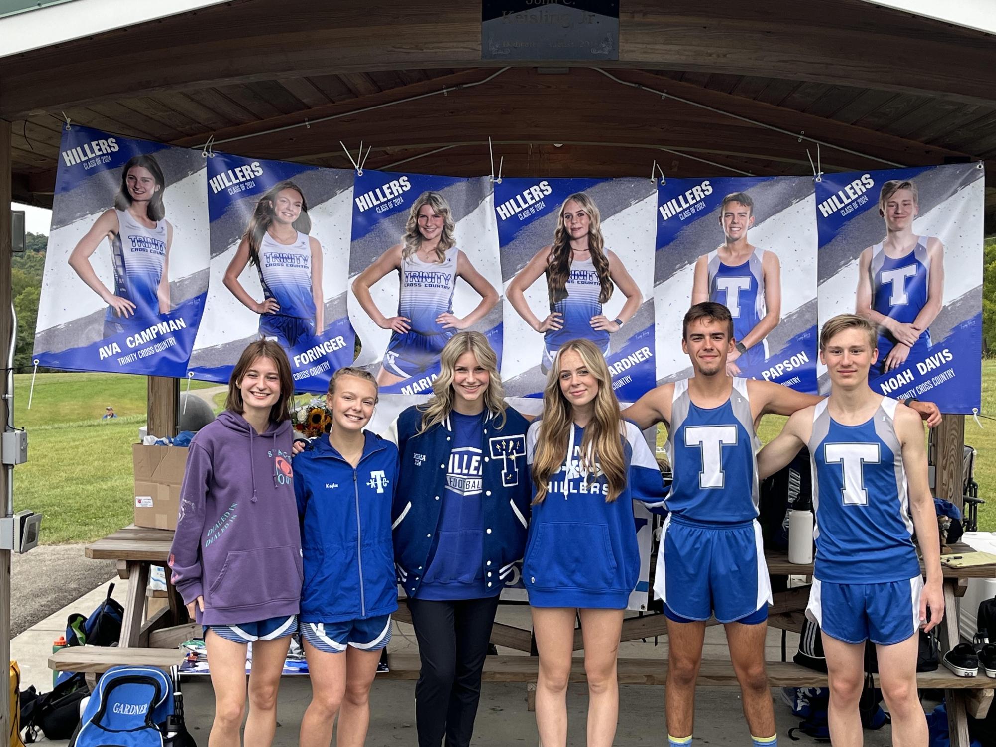 This years cross country seniors celebrate an amazing season! Ava Campman, Kaylee Foringer, Maria Giorgi, Timberly Gardner, Ben Papson and Noah Davis pose in front of their senior banners. 