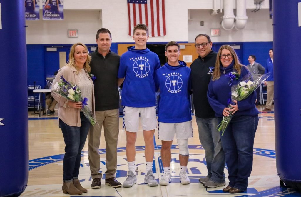 Captains of the team, Dante DeRubbo (L) and Tyler Johnson (R) stand together with their families on senior night to celebrate their years of success.