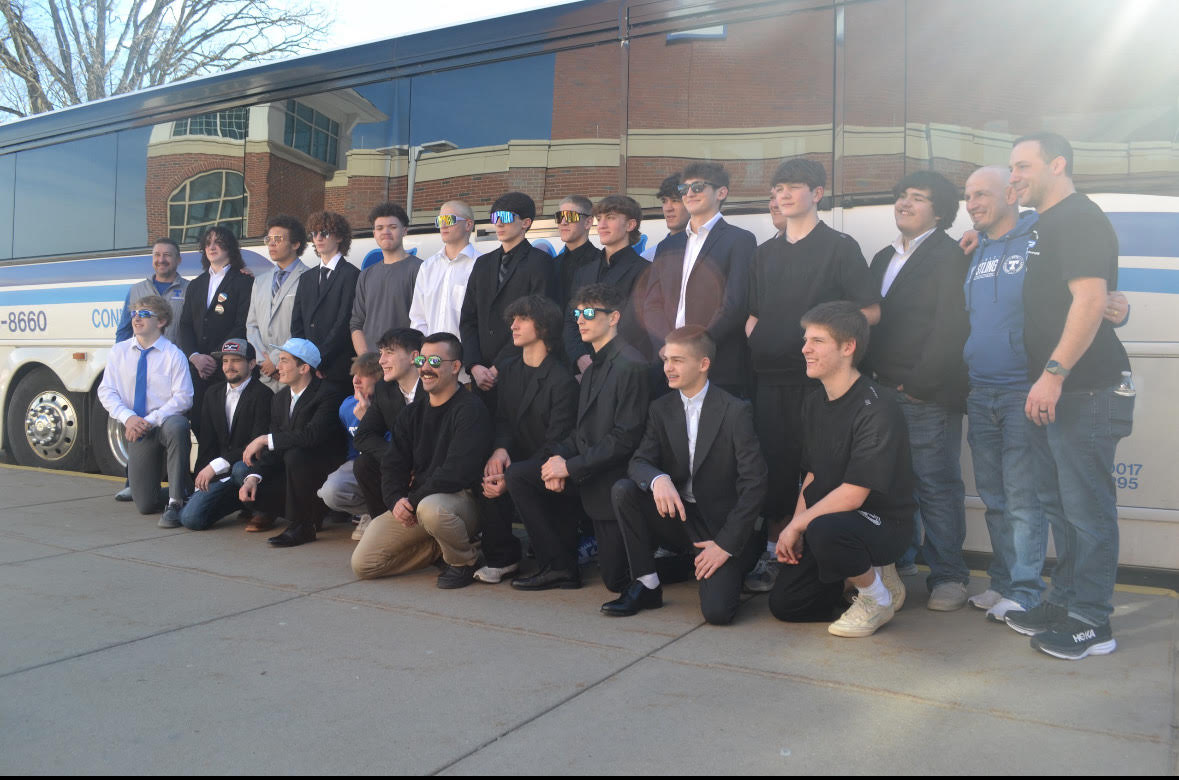 Trinity students lined the high school hallways to wish the team luck for the State matches in Hershey. The team poses for a photo as they board the bus to leave. 