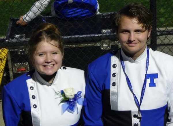 Senior drum majors Arwen Ikach and Nathan Sander smile brightly after playing in the Trinity Marching Band. Ikach and Sander had participated in band together for four years at Trinity High School.