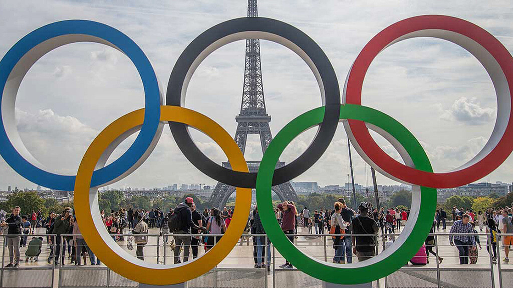 The Olympic Rings, installed in front of the Eiffel Tower, adorn the esplanade of the Trocadéro. The interlocked rings represent the five inhabited continents coming together, for the sake of sports.