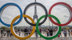 The Olympic Rings, installed in front of the Eiffel Tower, adorn the esplanade of the Trocadéro. The interlocked rings represent the five inhabited continents coming together, for the sake of sports.