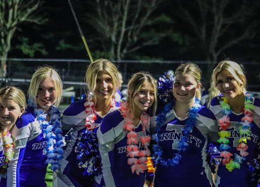 Seniors Sarah Burt and Taylor Layhue, and Juniors Chloe Bricker, Cicely Juliet, Morgan Layhue and Addison Mercurio have fun on the sidelines while stretching and warming up before taking the field.
