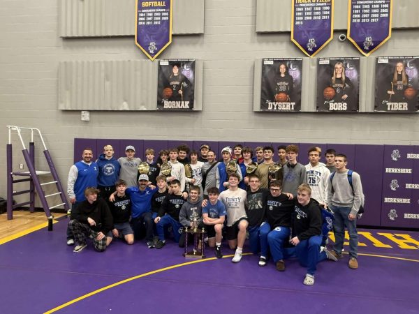 The boys happily line up to take a celebratory photo at Berkshire High School after their Battle for the Belt tournament with coaches Tarquinio, Buxton and Migyanko. 