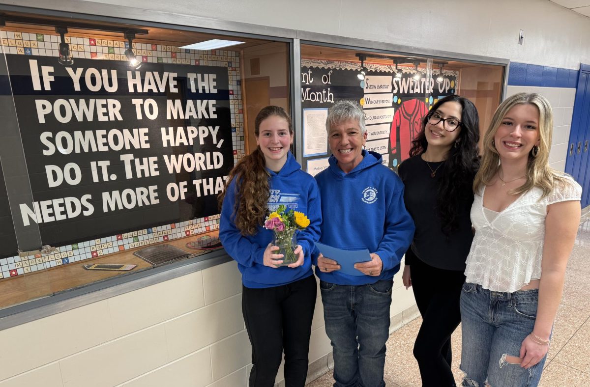 Members of the F.O.R. Club, Seniors Abby Bodart, Silvia Cardenas and Katie Davis, pose with Tascha Kopko after presenting her with a thank you gift for all of her hard work and dedication to Trinity.