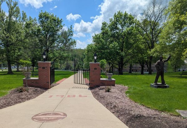 High school students drive and walk past this concrete path every day, the path they will walk on the day of graduation. The brown marble medallion seen in the picture marks where a ginkgo tree once stood. This tree symbolizes resilience and hope, traits graduating students will need in their years after high school. 
