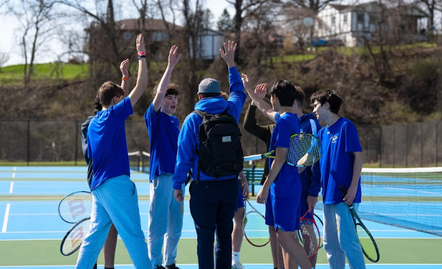 Teamwork is the foundation of the boy's tennis team. Pictured above, the close-knit group practices, plays and succeeds together.
